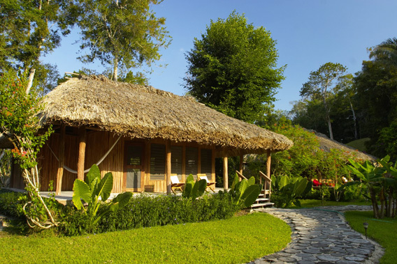 chan chich lodge, belize, thatched roof cabanas in the heart   of the Mayan empire in Belize and the tropical jungle 
in Belize.